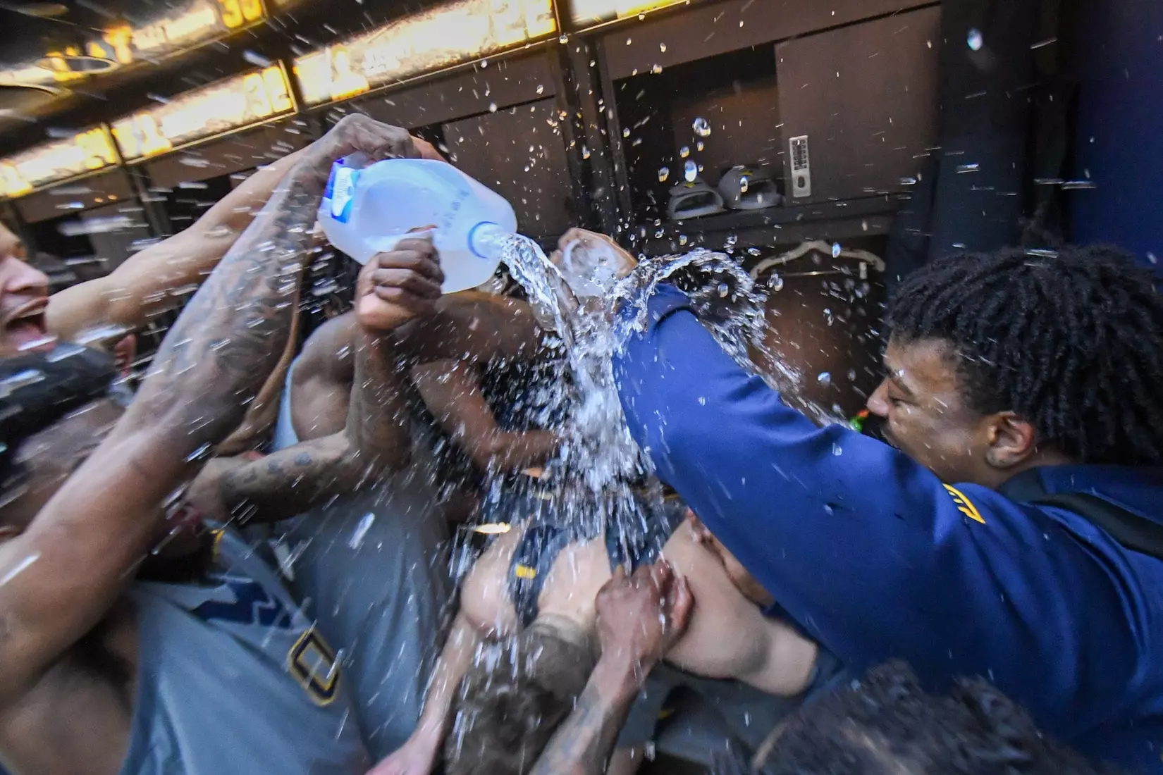 Erik Stevenson is watered in the locker room by his teammates after scoring 31 points.
