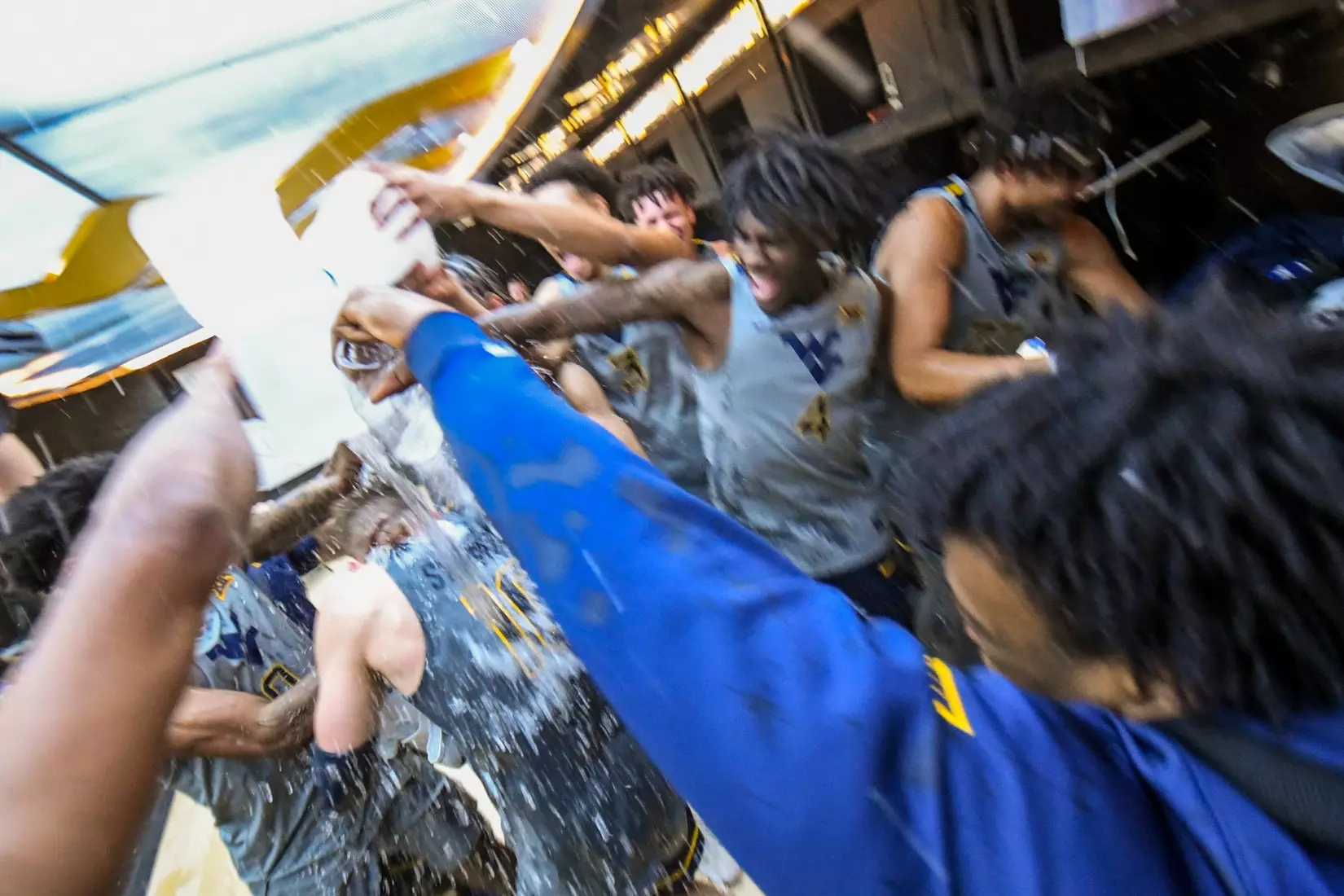 Erik Stevenson is watered in the locker room by his teammates after scoring 31 points.