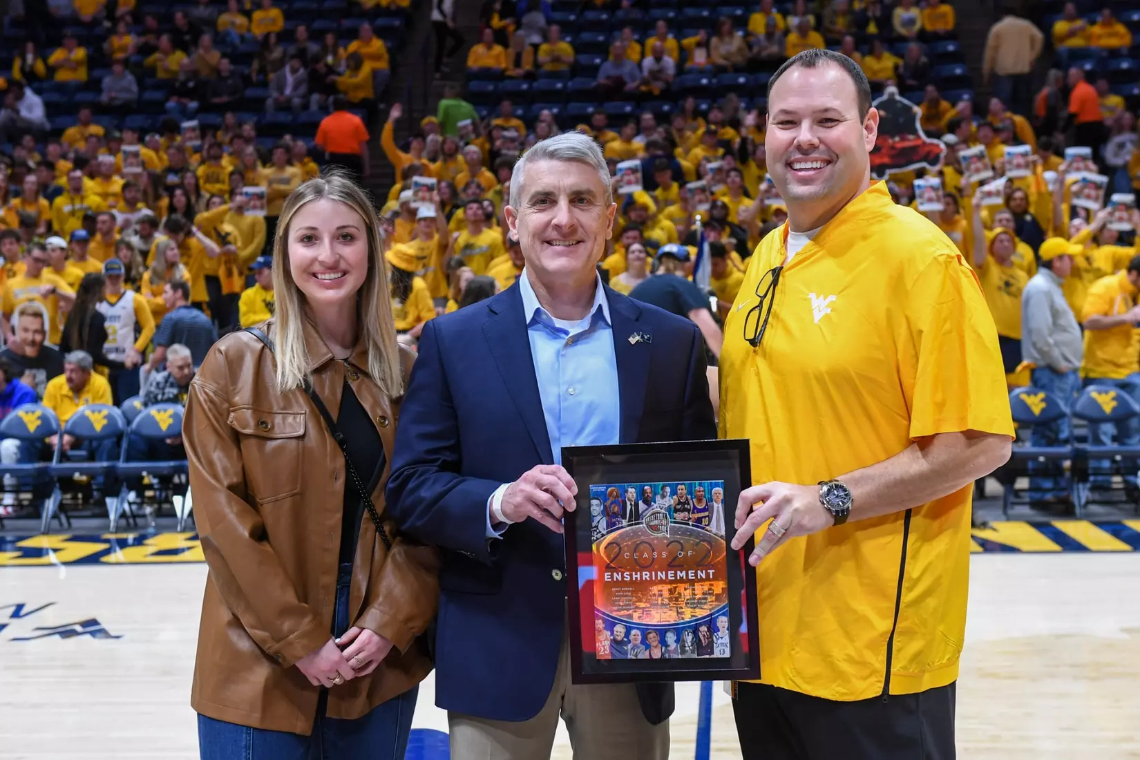WVU Director of Athletics Wren Baker presents the game sponsor award.
