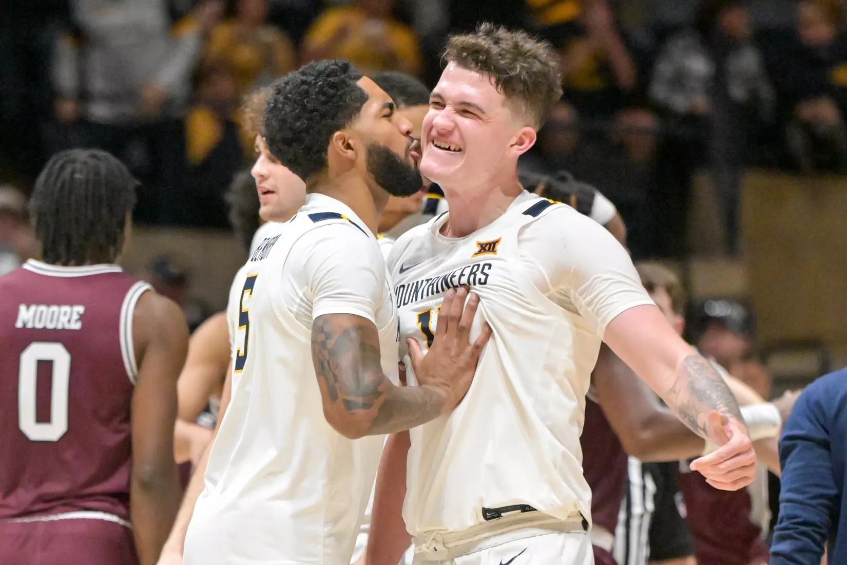 Jeremiah Bembry celebrates a Quinn Slazinski three-pointer.