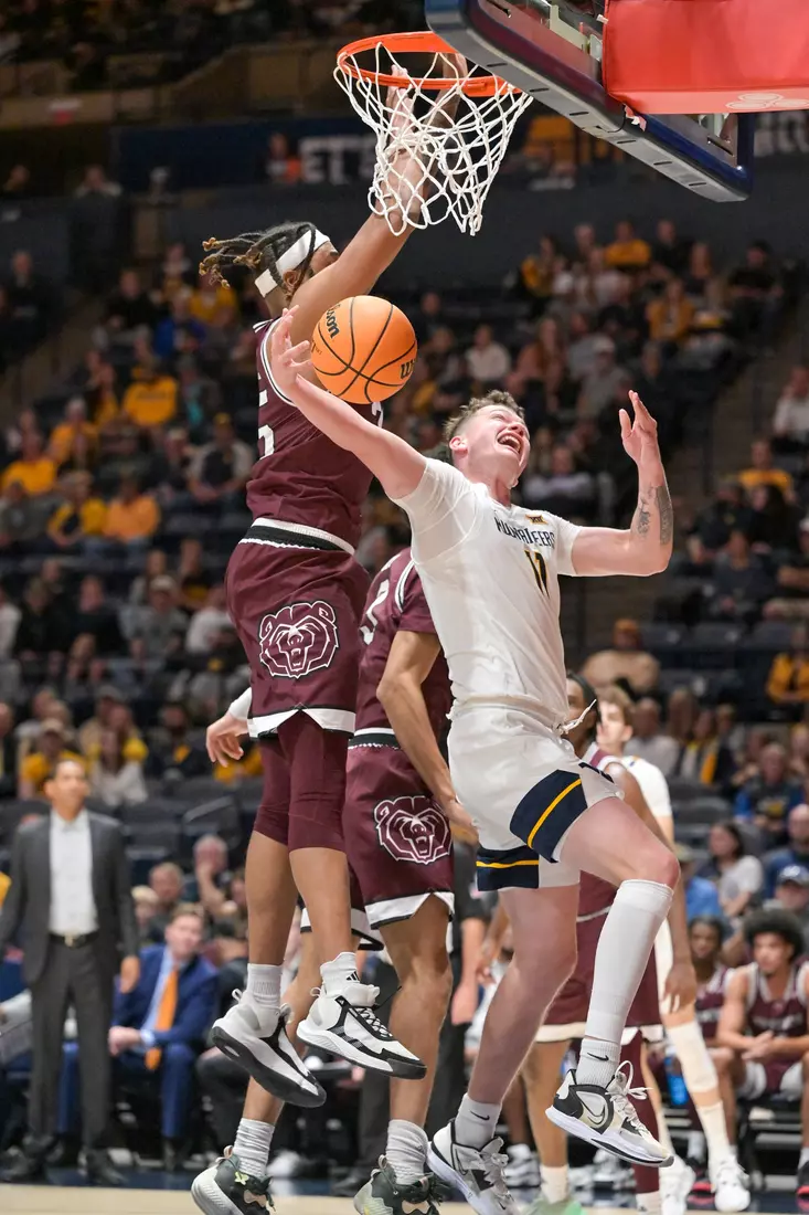 Quinn Slazinski is fouled on the way to the hoop.