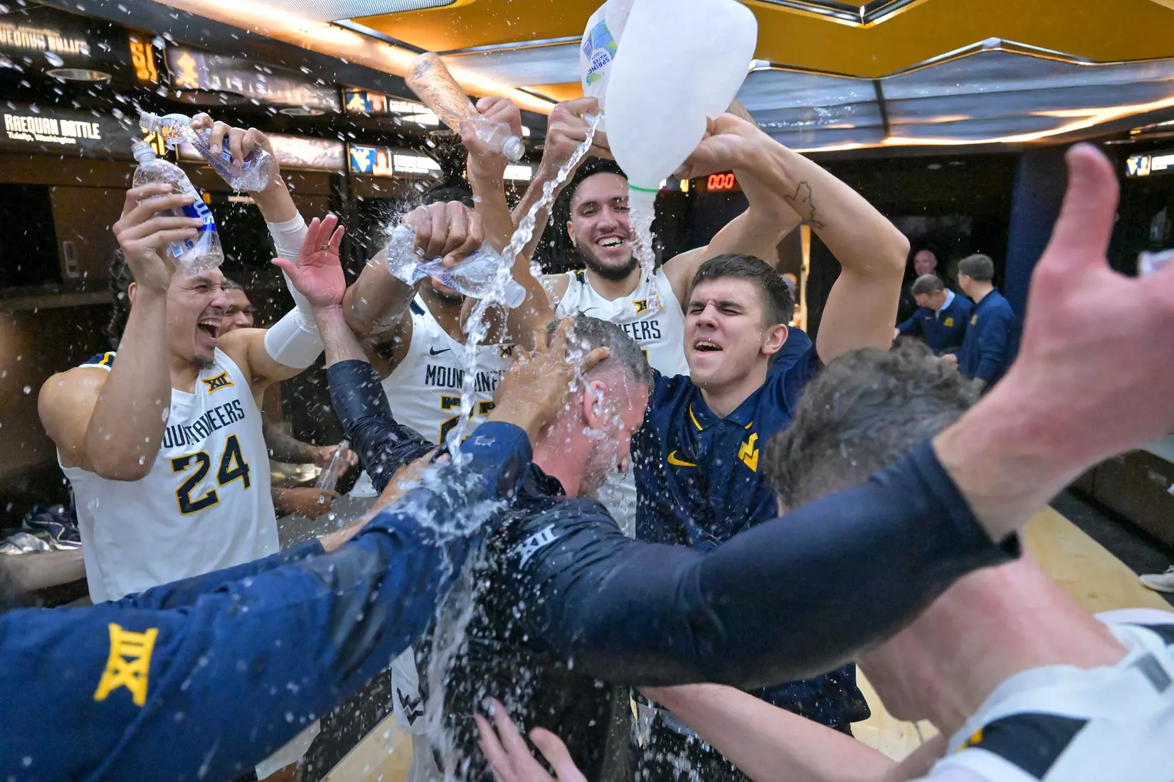 Head coach Josh Eilert is congratulated by his team on the court for his first ever win.