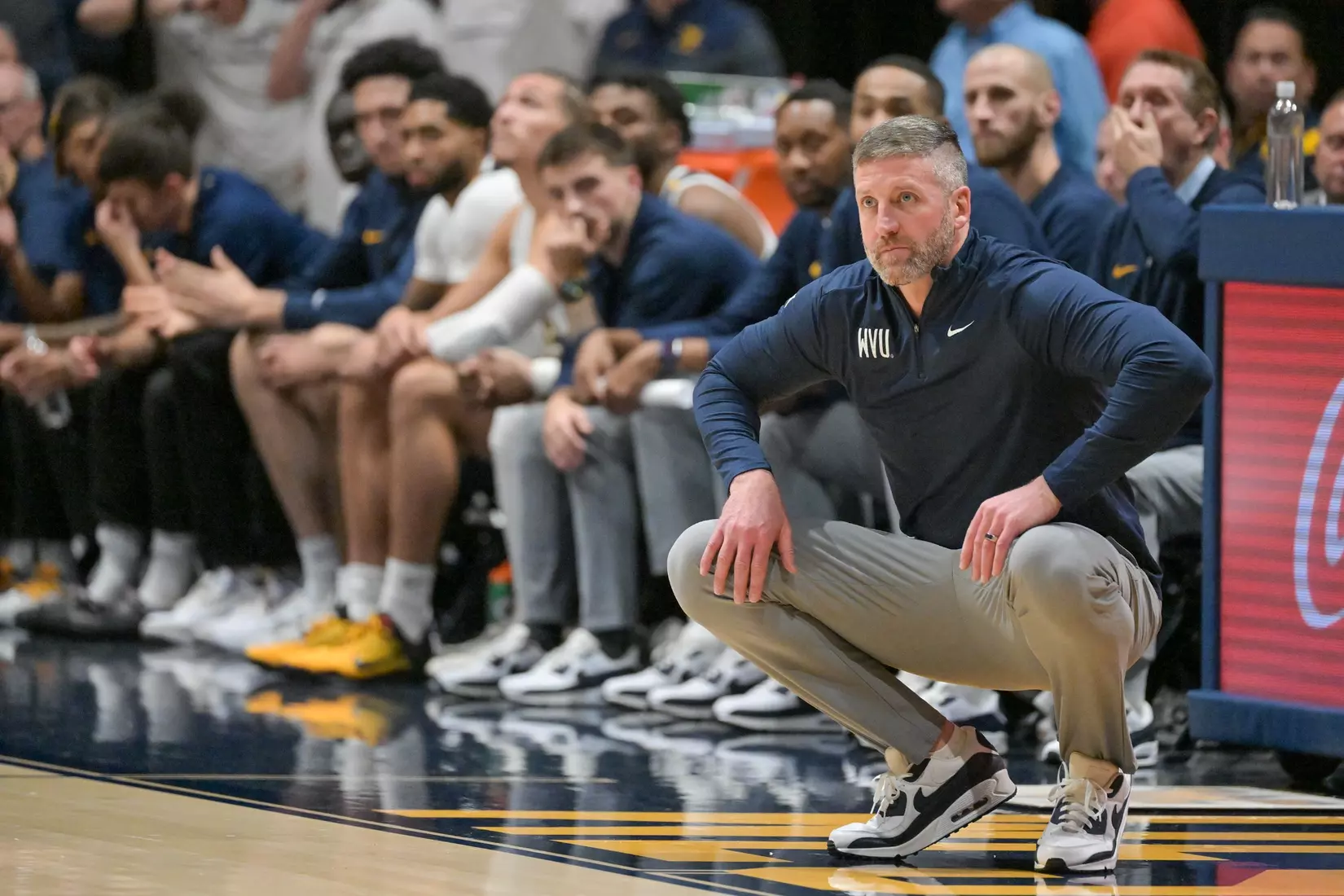 Head coach Josh Eilert watches.