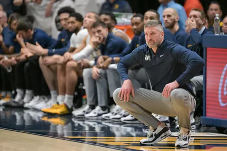 Head coach Josh Eilert watches.