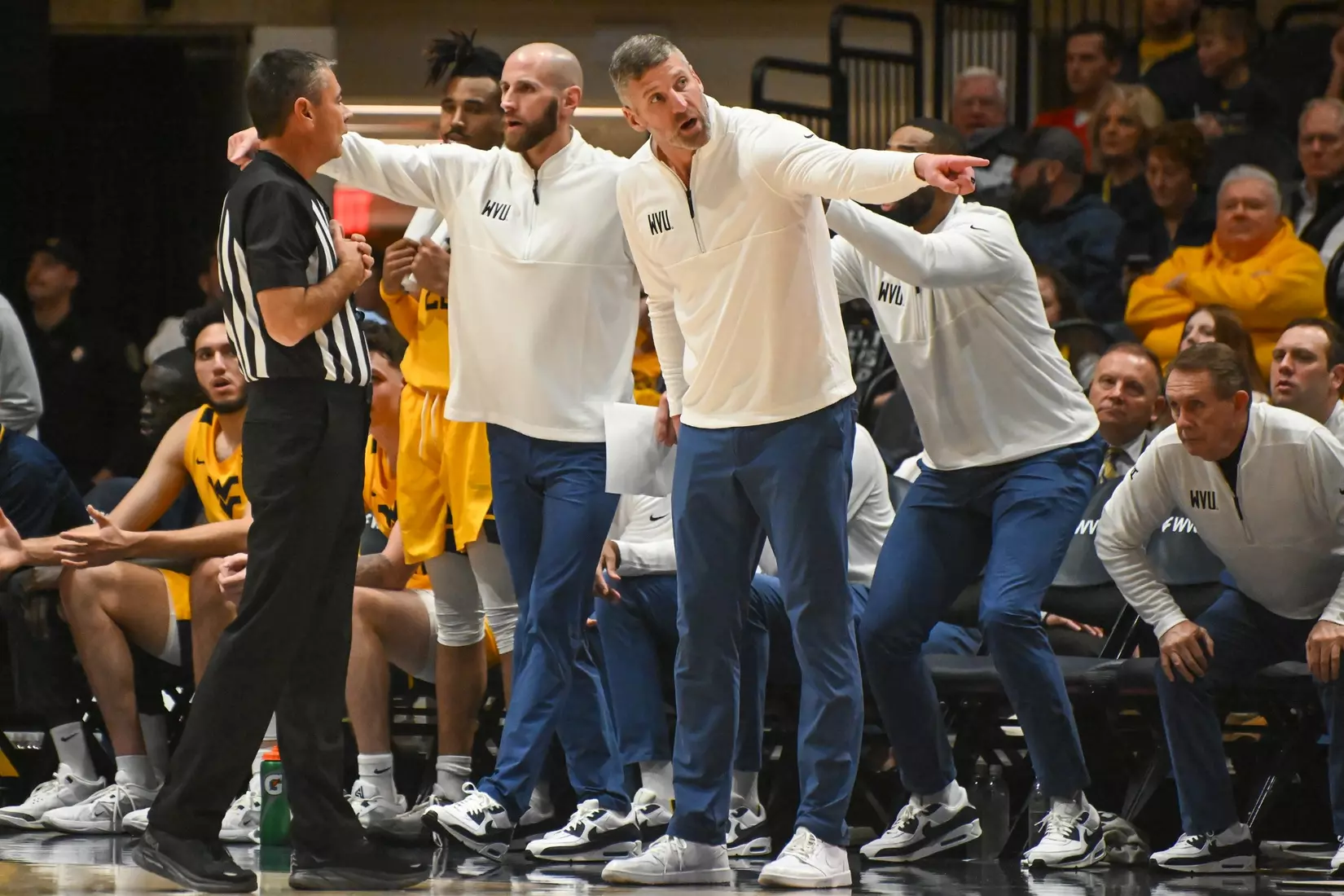 Head coach Josh Eilert talks with a referee.