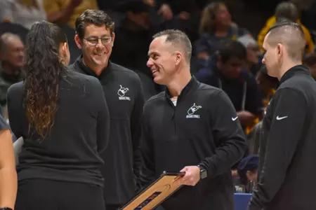 Mark Kellogg smiles during a timeout.