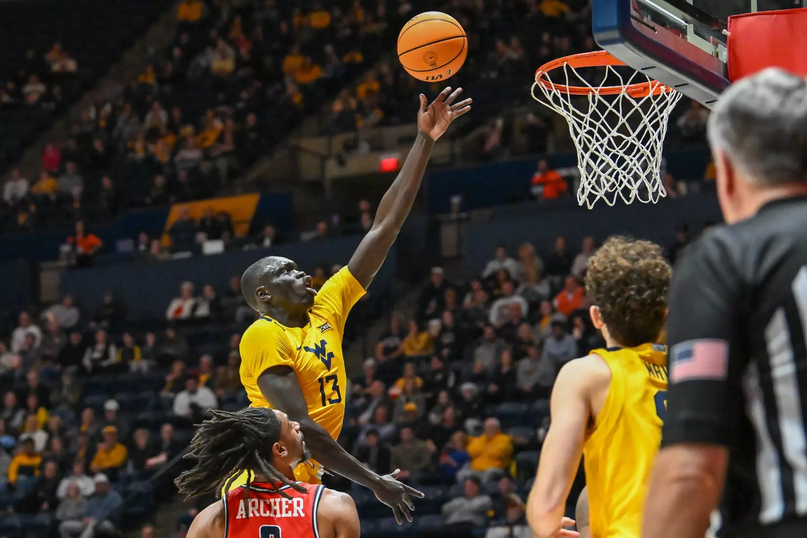 Akok Akok lays in the ball in the basket.