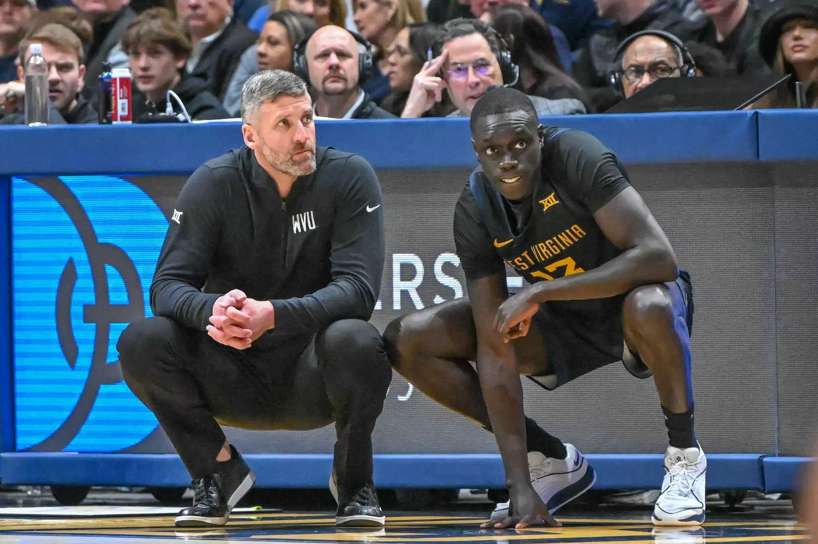 Josh Eilert waits with Akok Akok to enter the game.