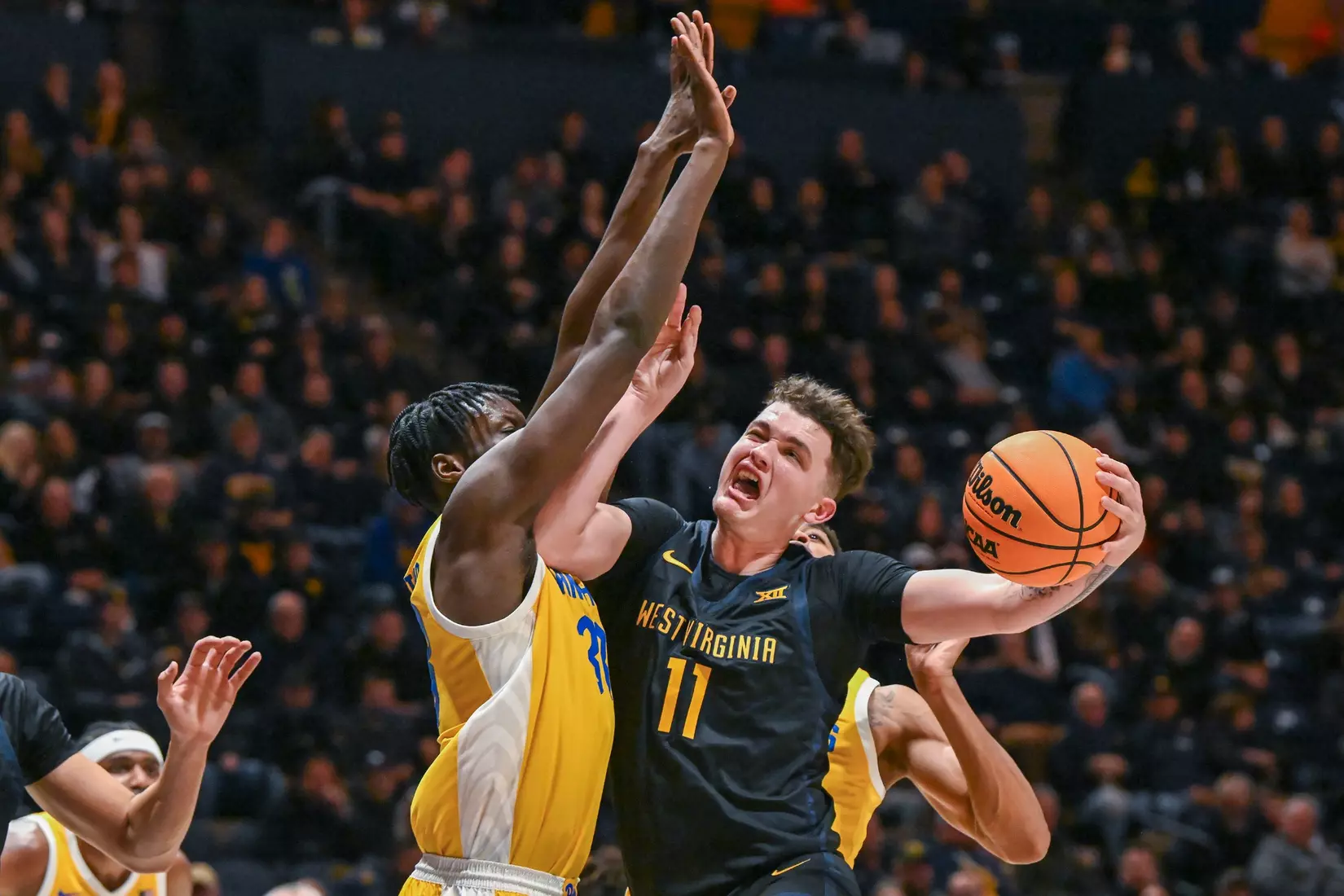 Quinn Slazinski shoots around a defender.