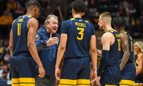 Bob Huggins gives final instructions during a late timeout.