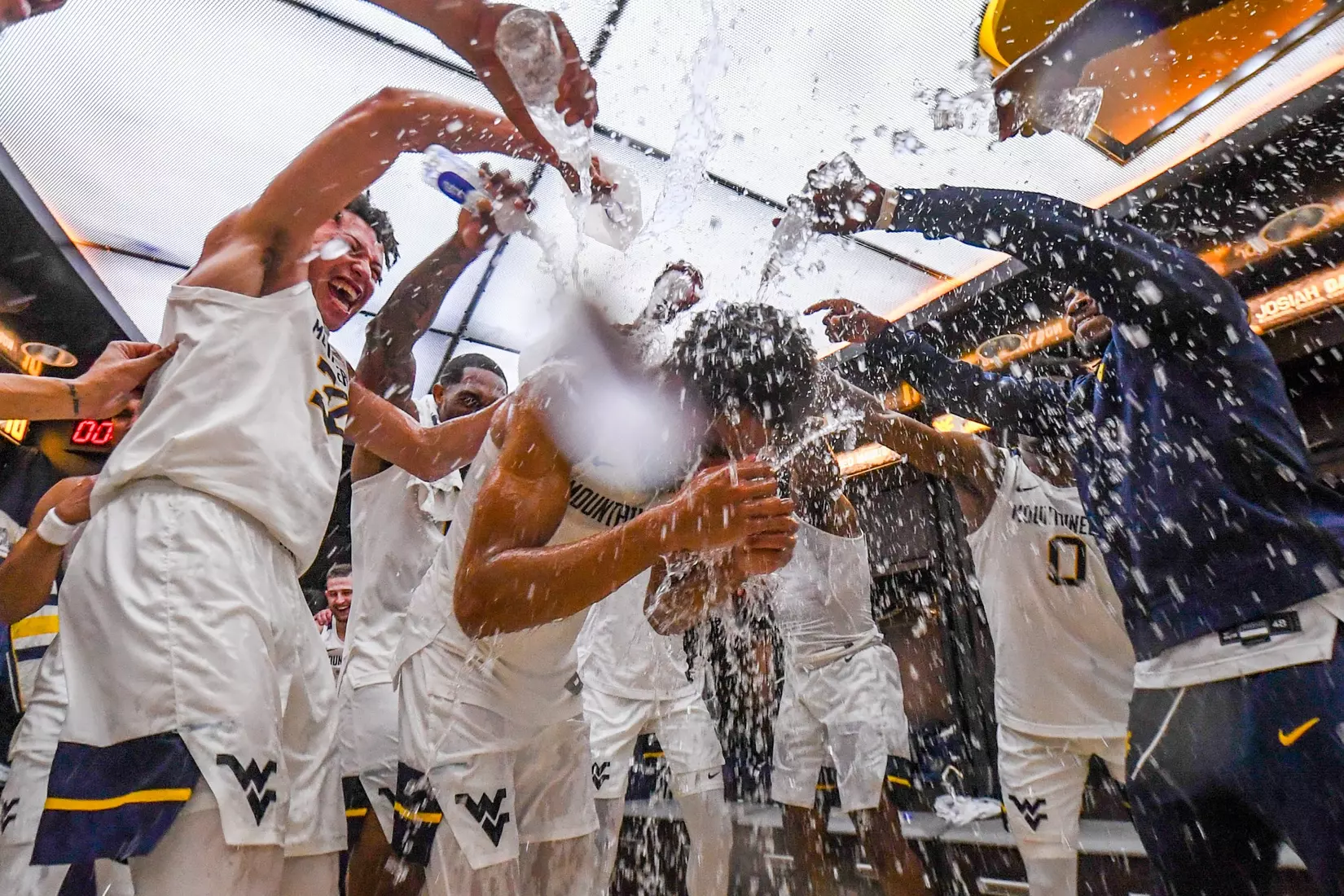 Emmitt Matthews Jr. gets the water bath in the locker room.