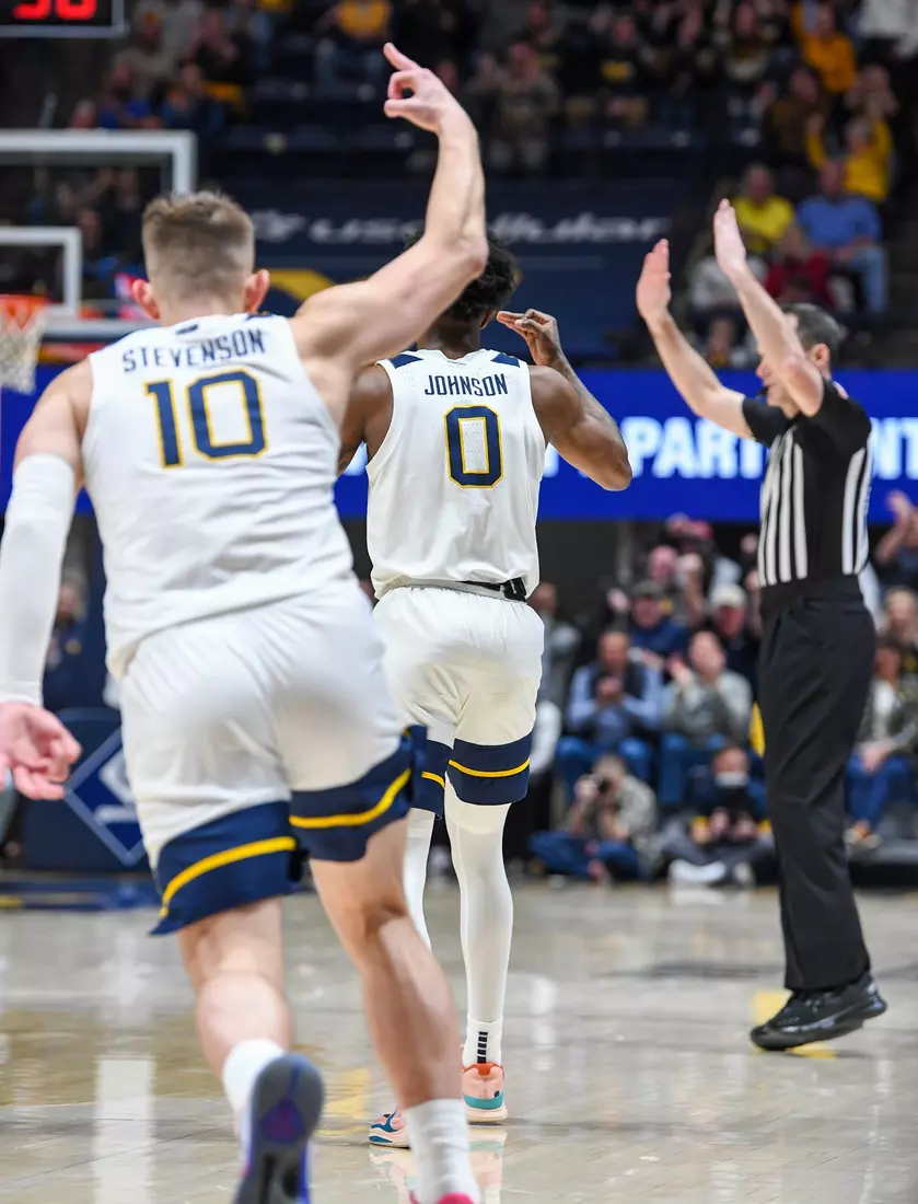 Kedrian Johnson and Erik Stevenson celebrate a three-pointer.