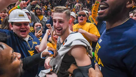 Erik Stevenson celebrates the win in the student section.