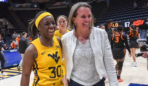 Madisen Smith and Coach Dawn Plitzuweit enjoy the win.