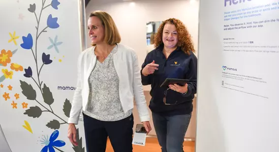 Coach Dawn Plitzuweit gets a tour of the new Lactation Pod in the WVU Coliseum.