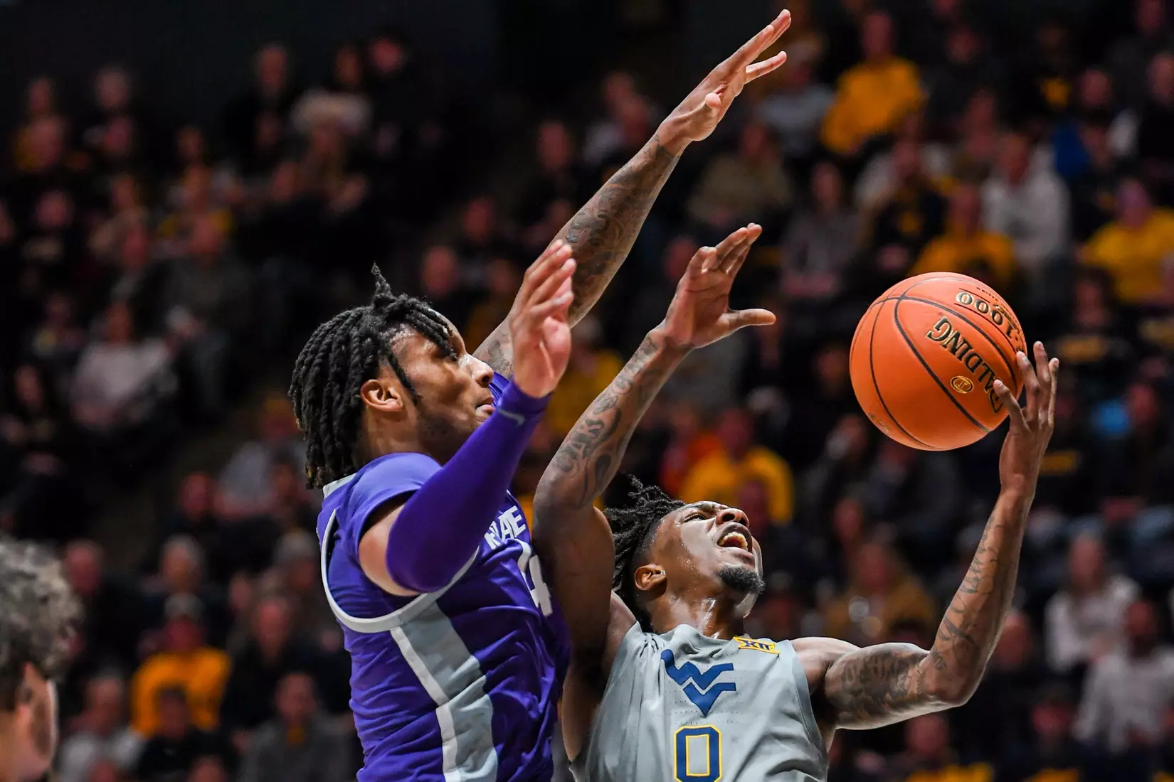 Kedrian Johnson is fouled while shooting.
