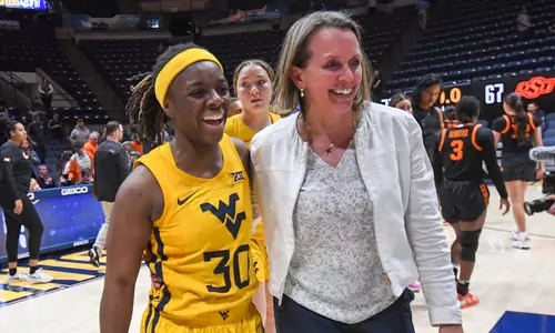 Madisen Smith and Coach Dawn Plitzuweit enjoy the win.