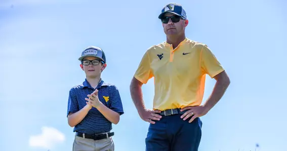 Coach Sean Covich and his son Keenan watch the action at Pete Dye Golf Club.