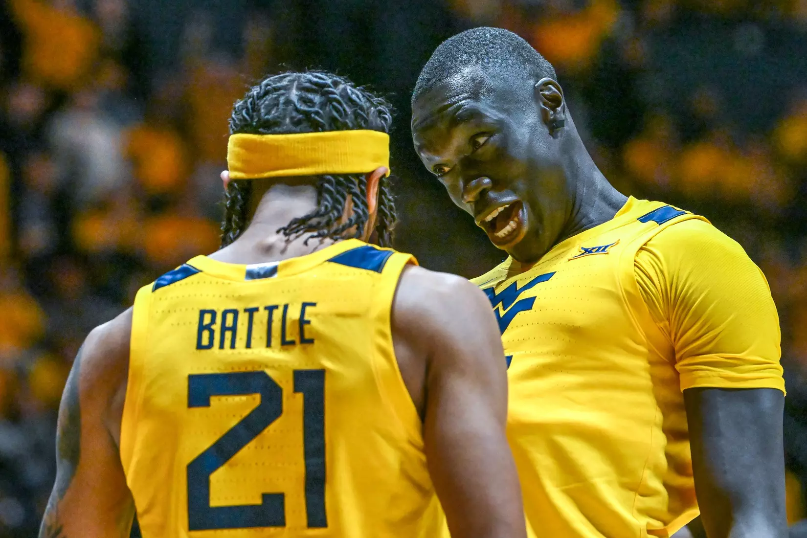 Akok Akok celebrates a late slam dunk with RaeQuan Battle.