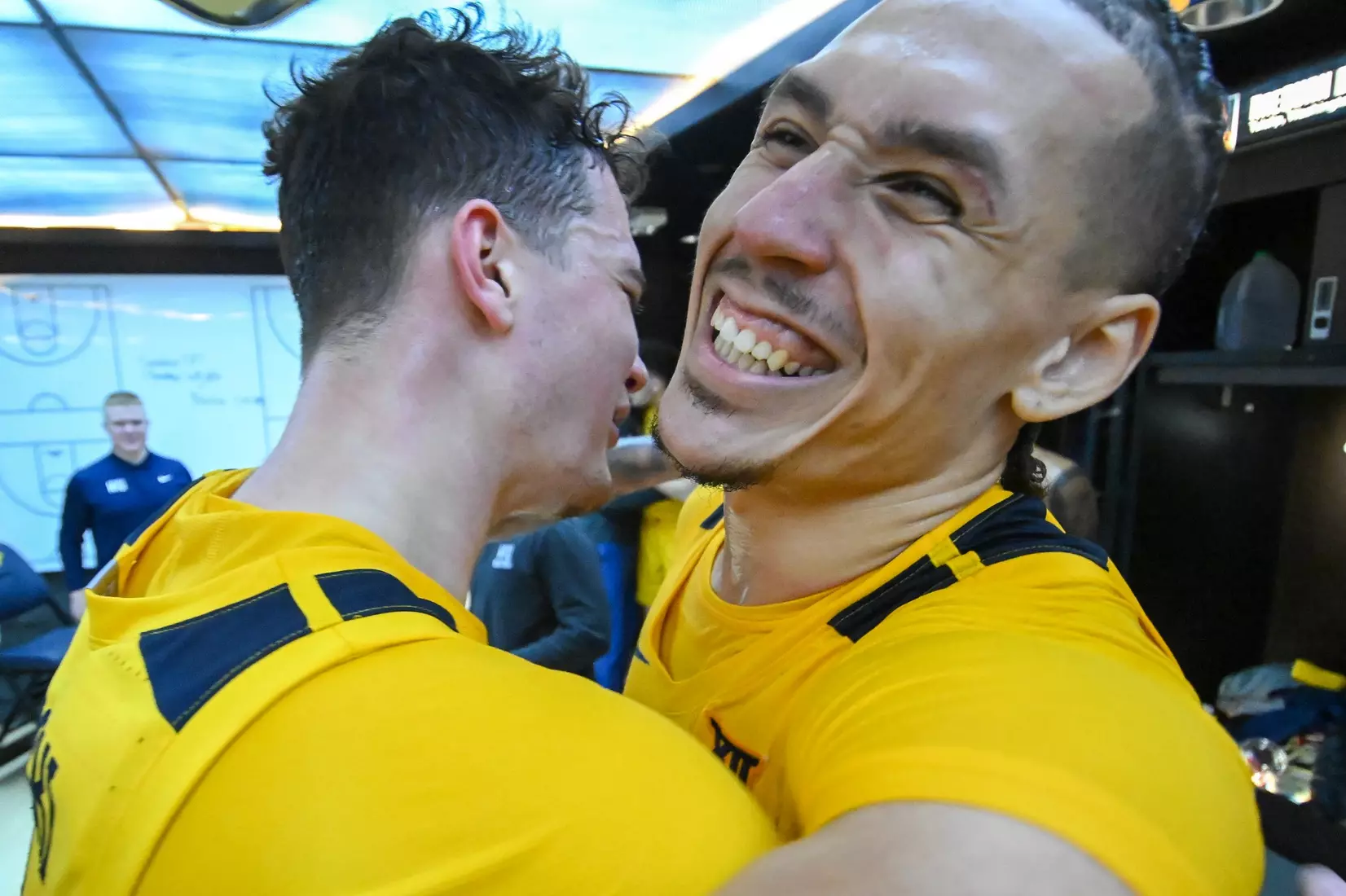 Quinn Slazinski and Patrick Suemnick celebrate the win in the locker room.