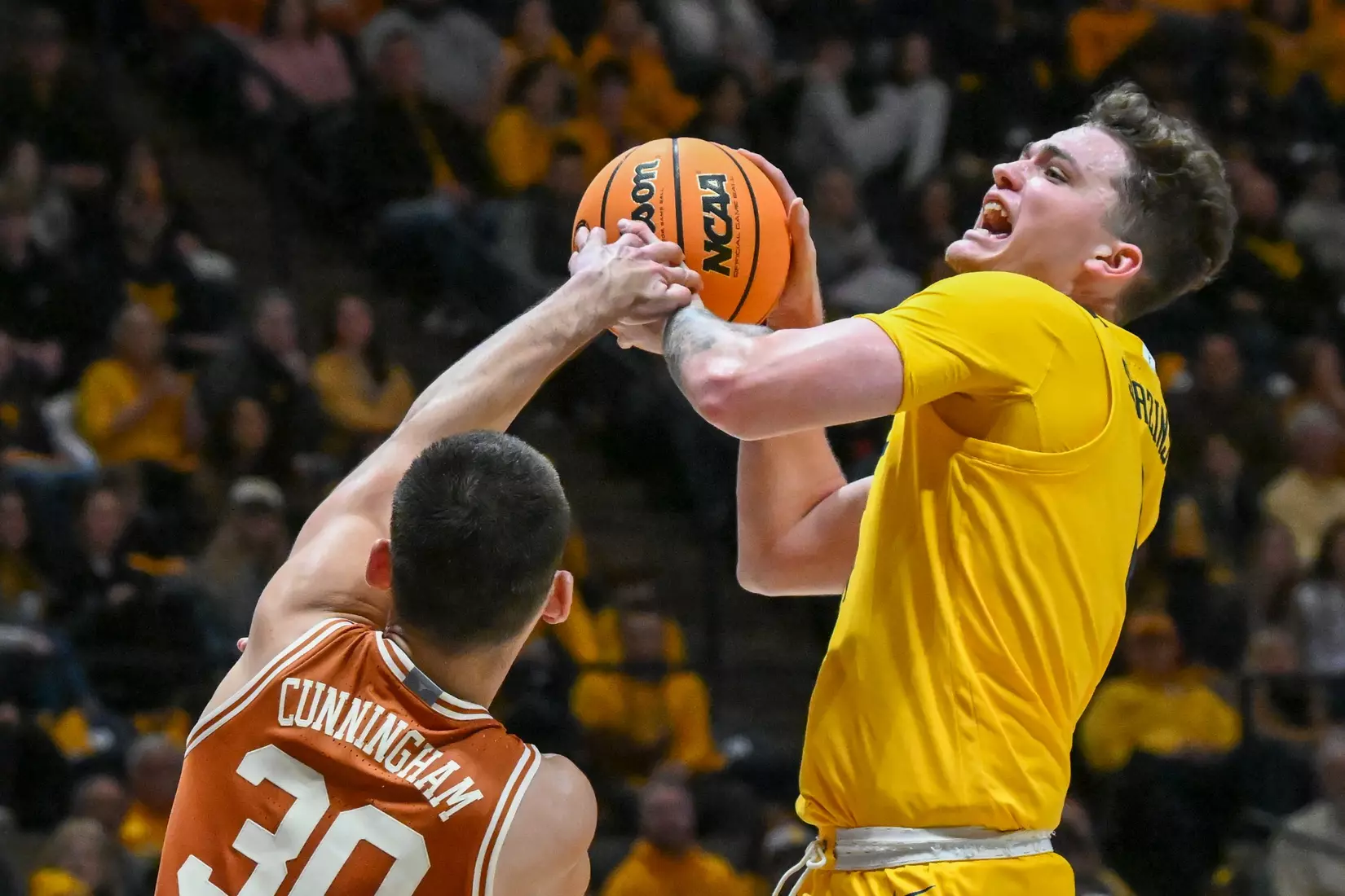 Quinn Slazinski is fouled while shooting.