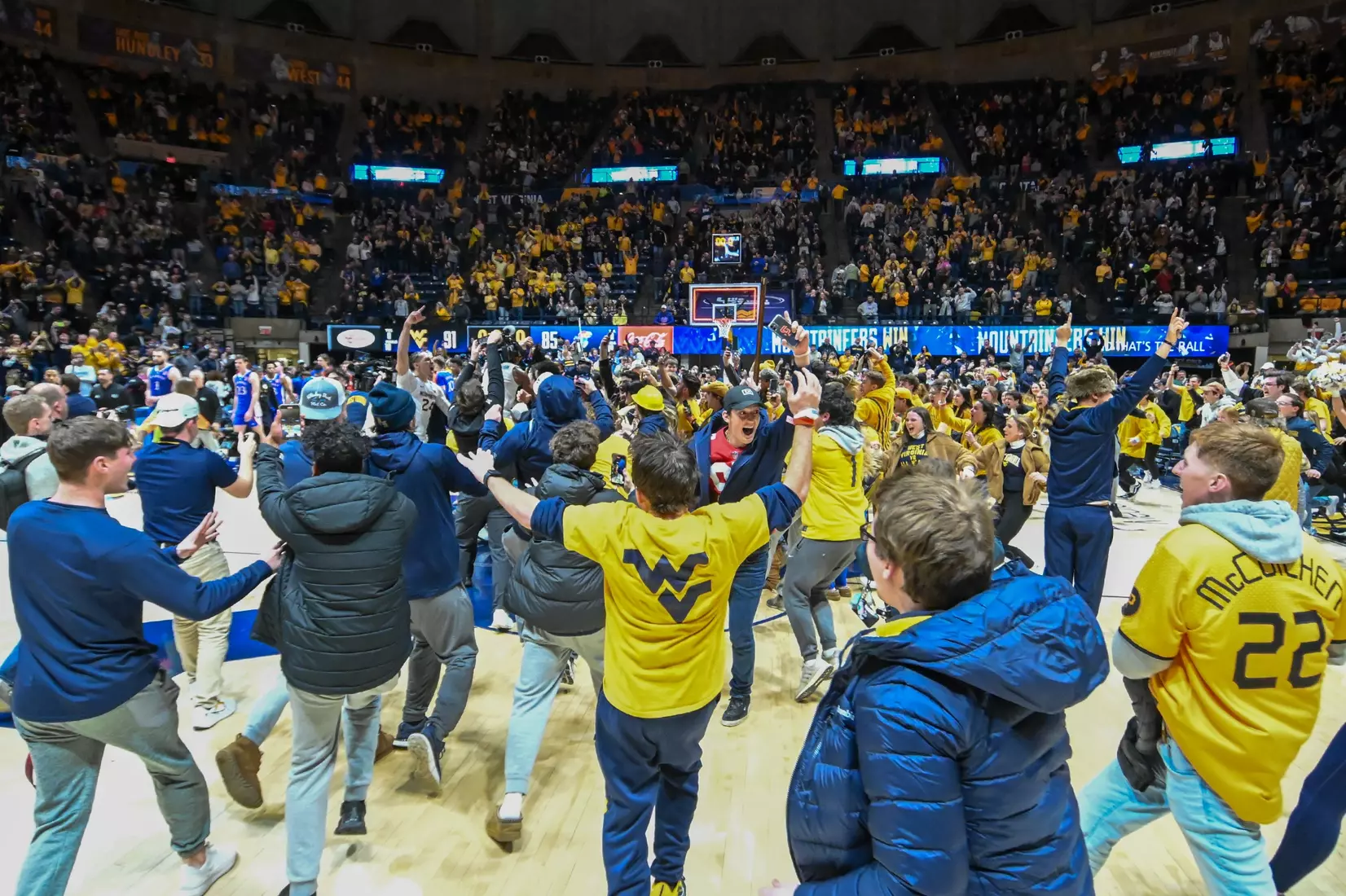 The fans rush the court after the win over Kansas.