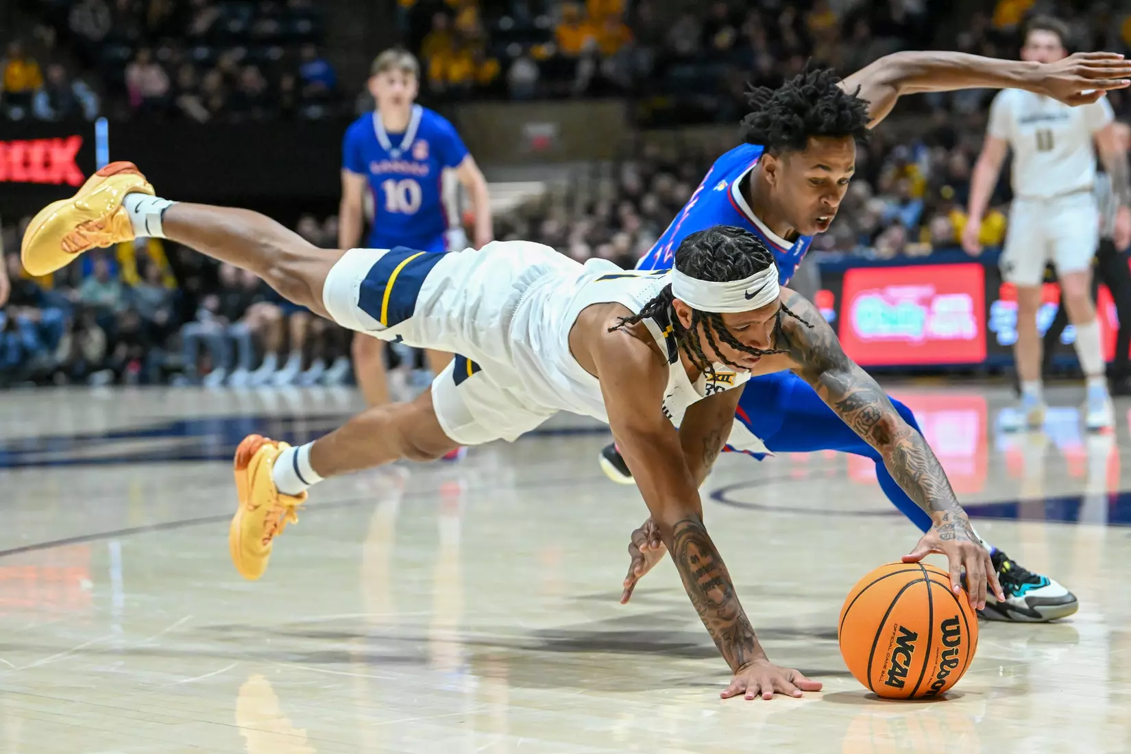 RaeQuan Battle dives for a loose ball during first half action.