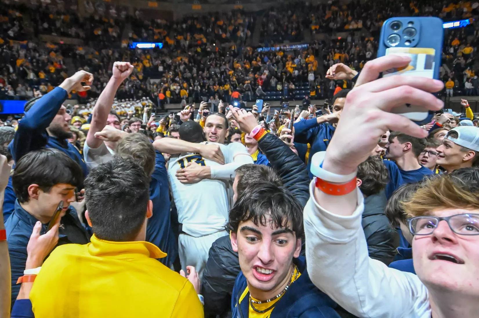 Patrick Suemnick and Akok Akok celebrate among the fans.