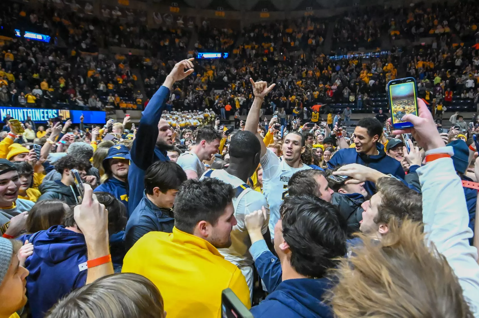 Patrick Suemnick and Akok Akok celebrate among the fans.