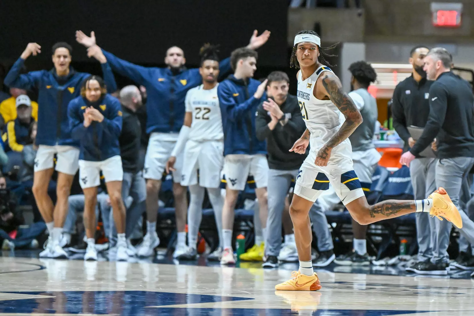 RaeQuan Battle and his teammates celebrate a three-pointer.