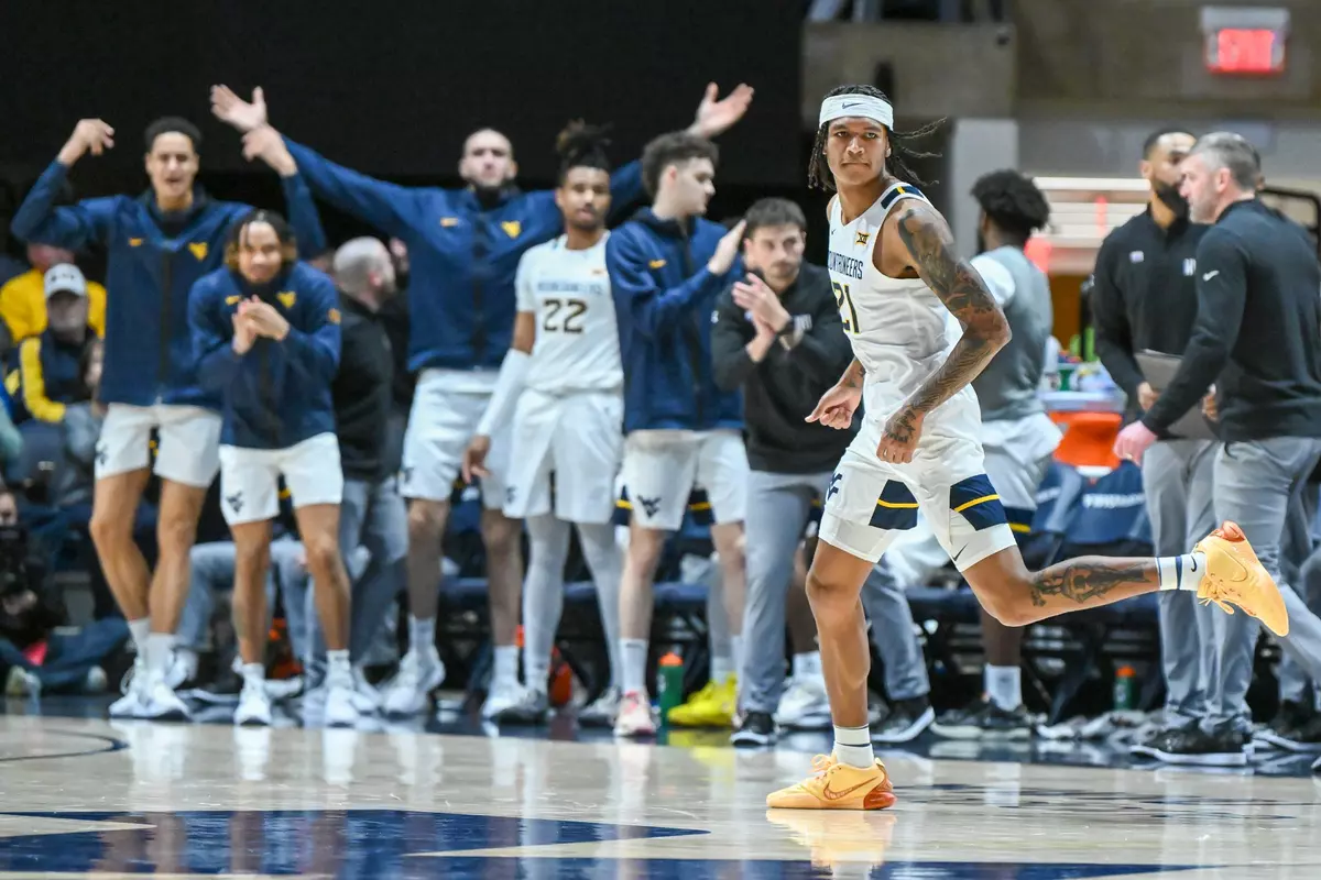 RaeQuan Battle and his teammates celebrate a three-pointer.