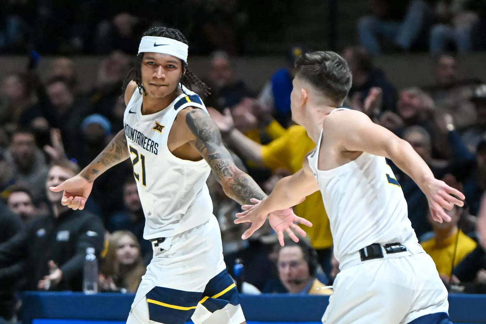 RaeQuan Battle is congratulated by Kerr Kriisa for a first half three-pointer.
