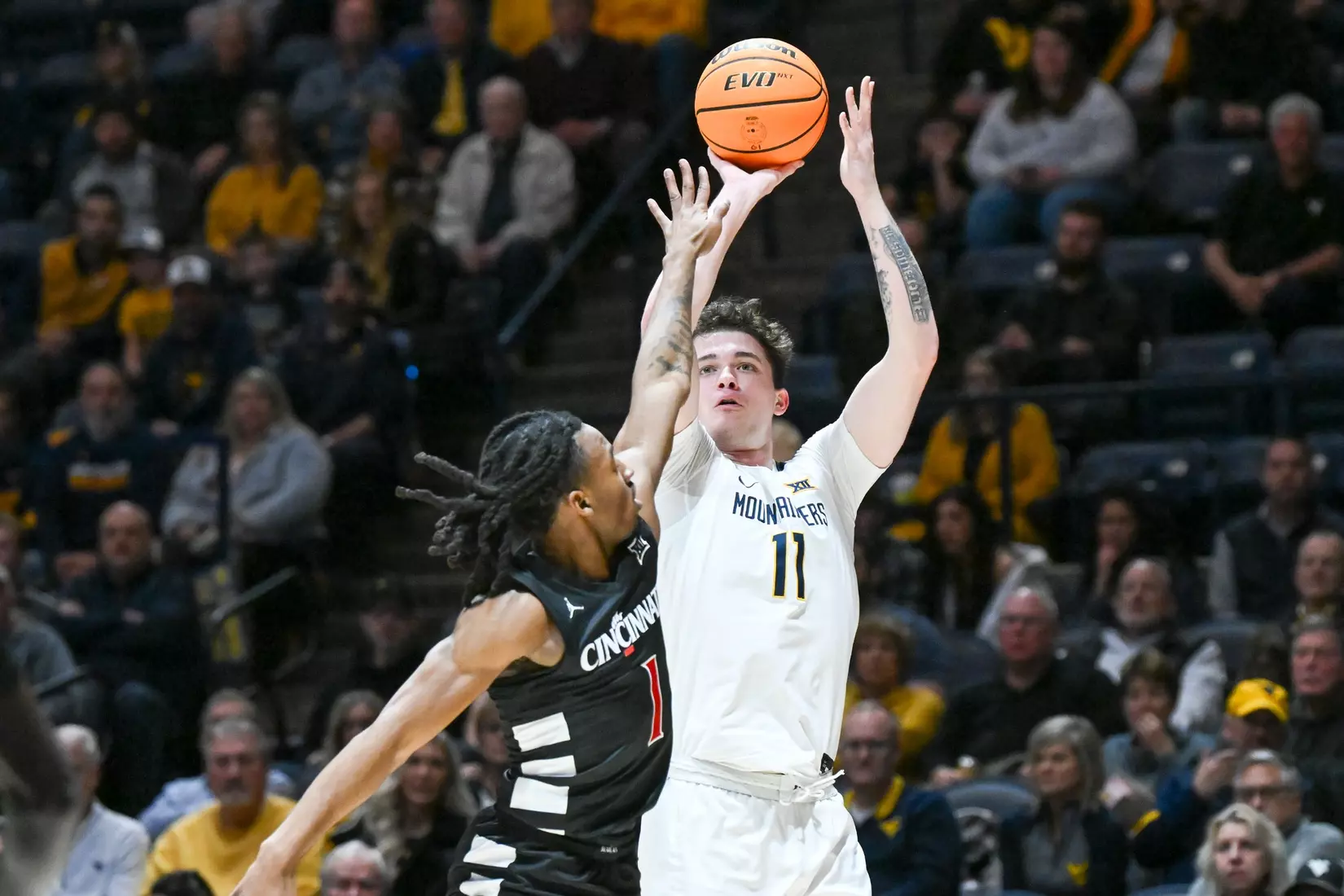 Quinn Slazinski shoots and hits a three-pointer.