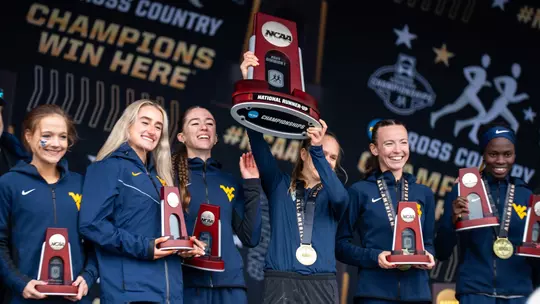 Cross Country team celebrates with NCAA Championship Runner Up trophy