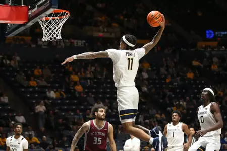 West Virginia Mountaineers guard Jonathan Powell (11) dunks on Tuesday, December 10, 2024 William Wotring