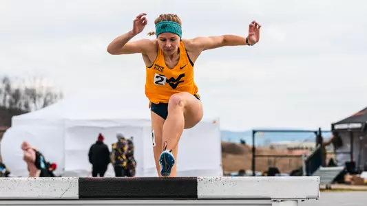 Zara Zervos running the 3,000 meter steeplechase
