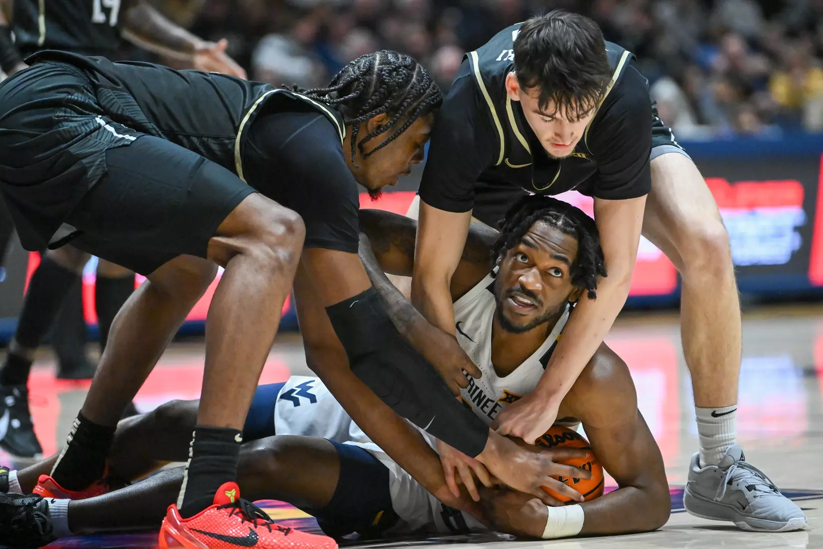 Kobe Johnson lands on the loose ball.