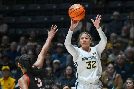 Kyah Watson hits a three-pointer.