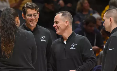 Mark Kellogg smiles during a timeout.