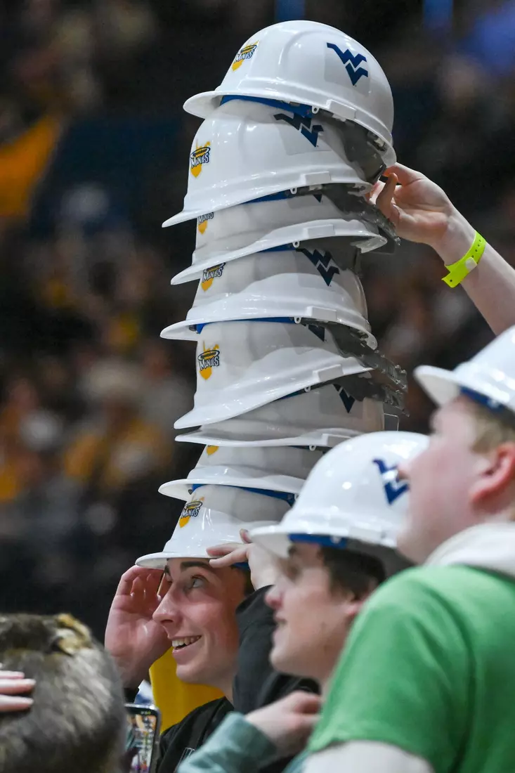 WVU students stack the Maniac hard hats.