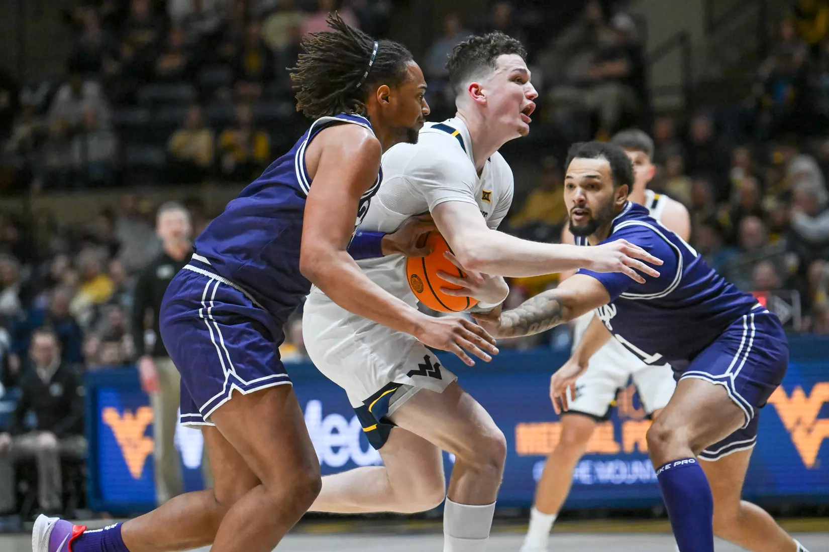 Quinn Slazinski is fouled while driving to the basket.
