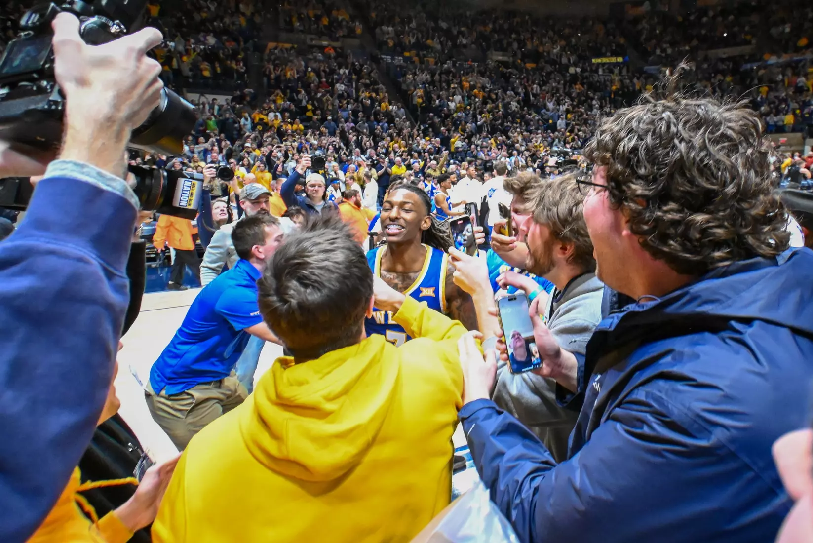 Javon Small celebrates at the buzzer as the fans rush the floor.