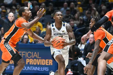 Javon Small drives to the basket during first half action against Oklahoma St.