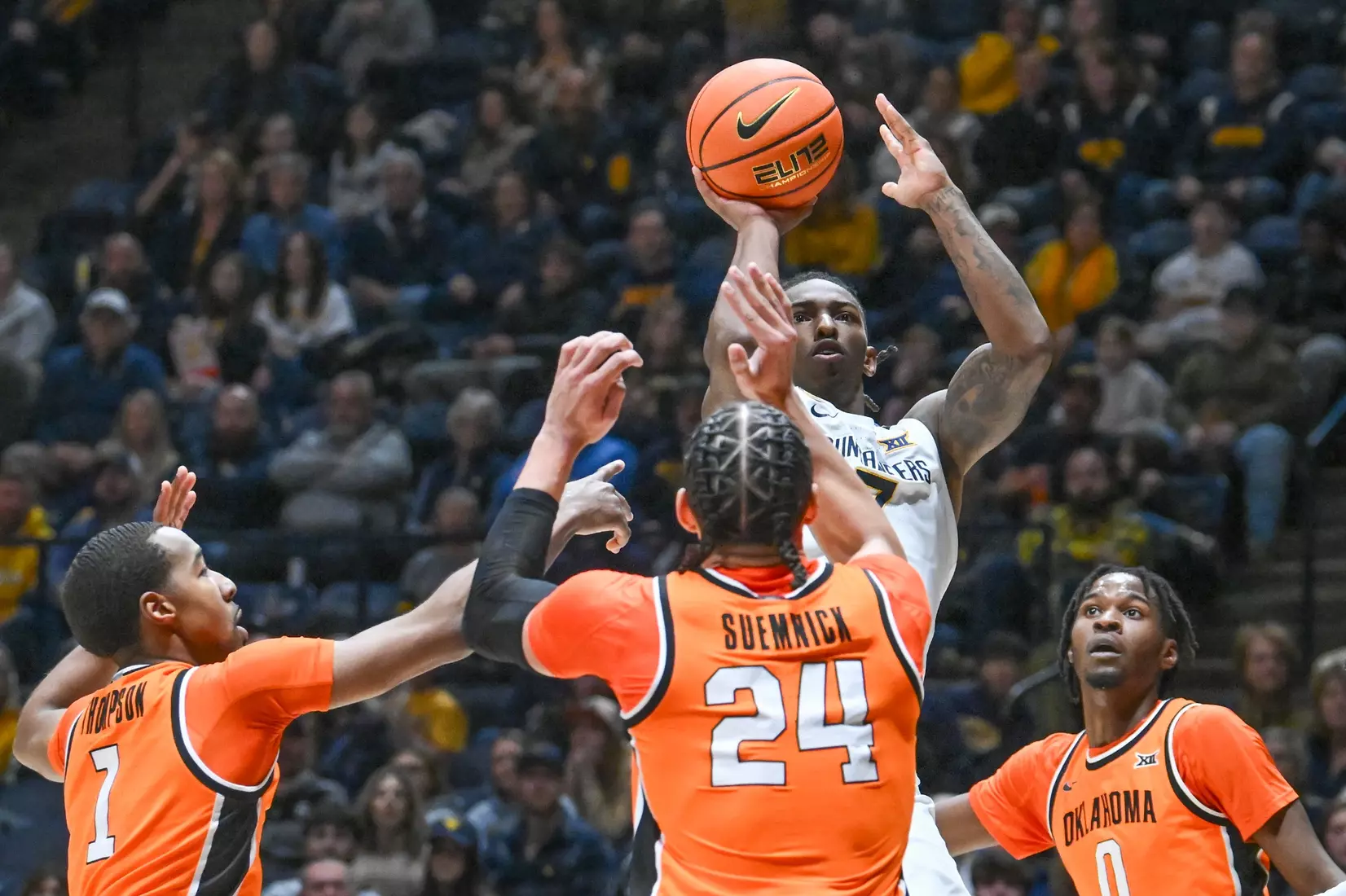 Javon Small shoots over three defenders during first half action against Oklahoma St.