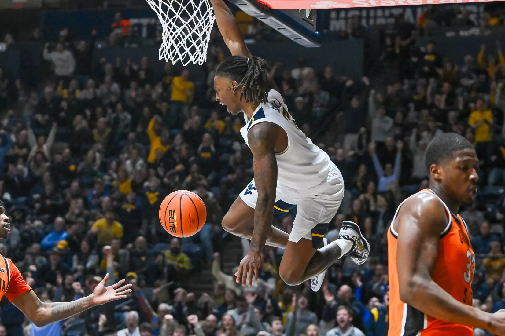 Javon Small slam dunks during first half action against Oklahoma St.