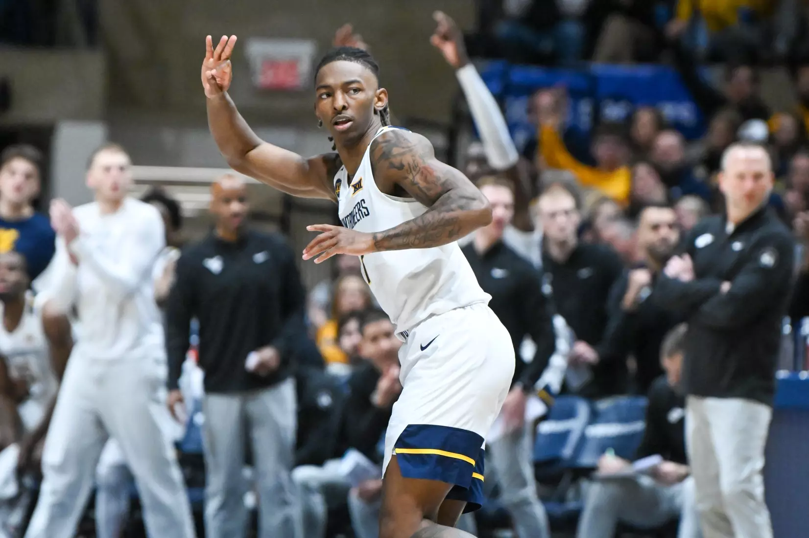 Javon Small celebrates. a three-pointer during first half action against Oklahoma St.