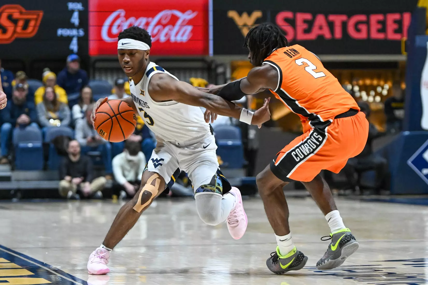 KJ Tenner drives past a defender during first half action against Oklahoma St.