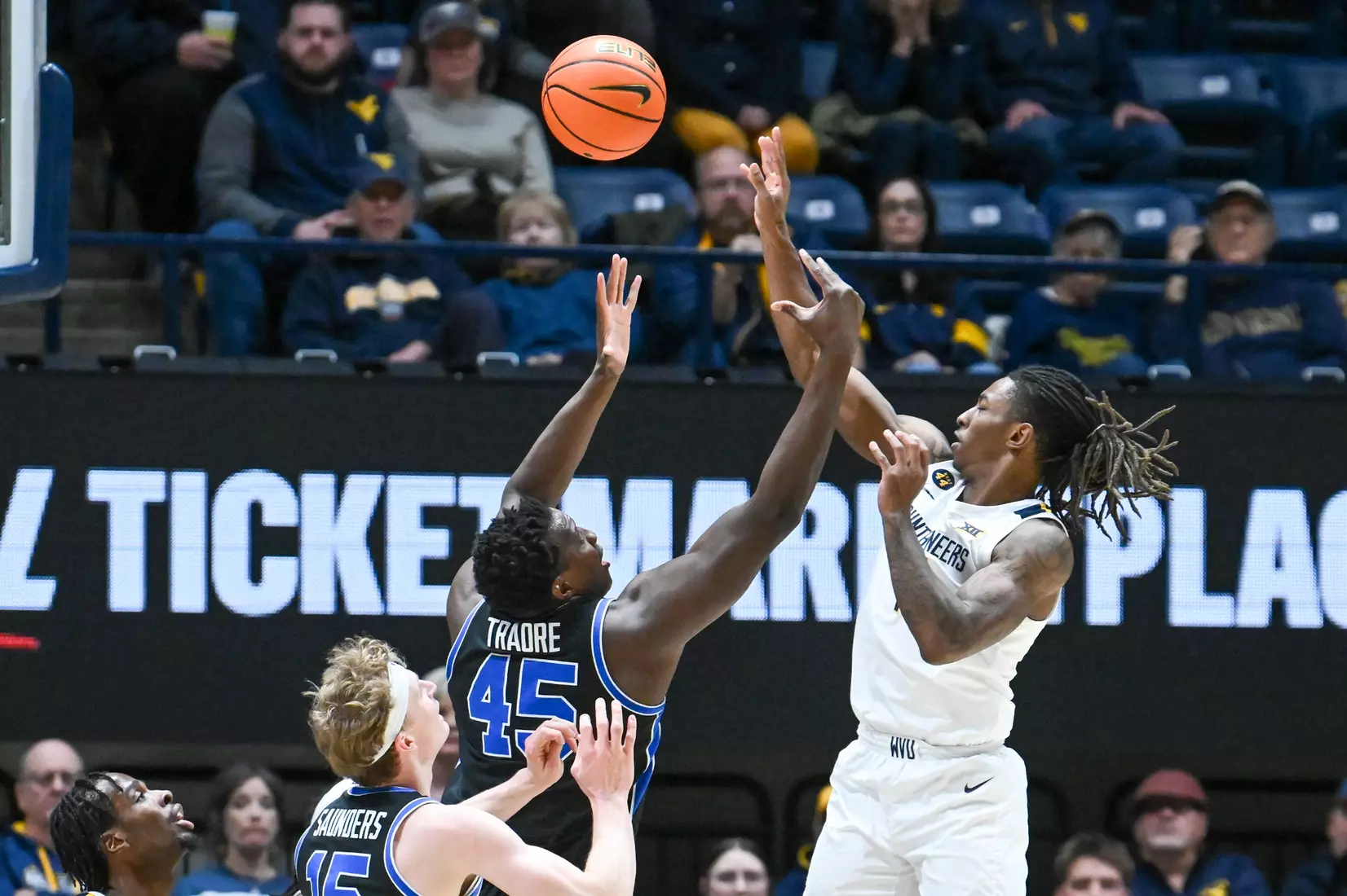 Javon Small bats the ball to a teammate on a rebound attempt.