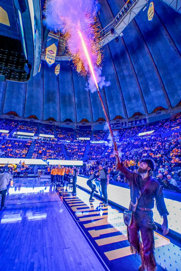 Mountaineer mascot Braden Adkins fires the musket.