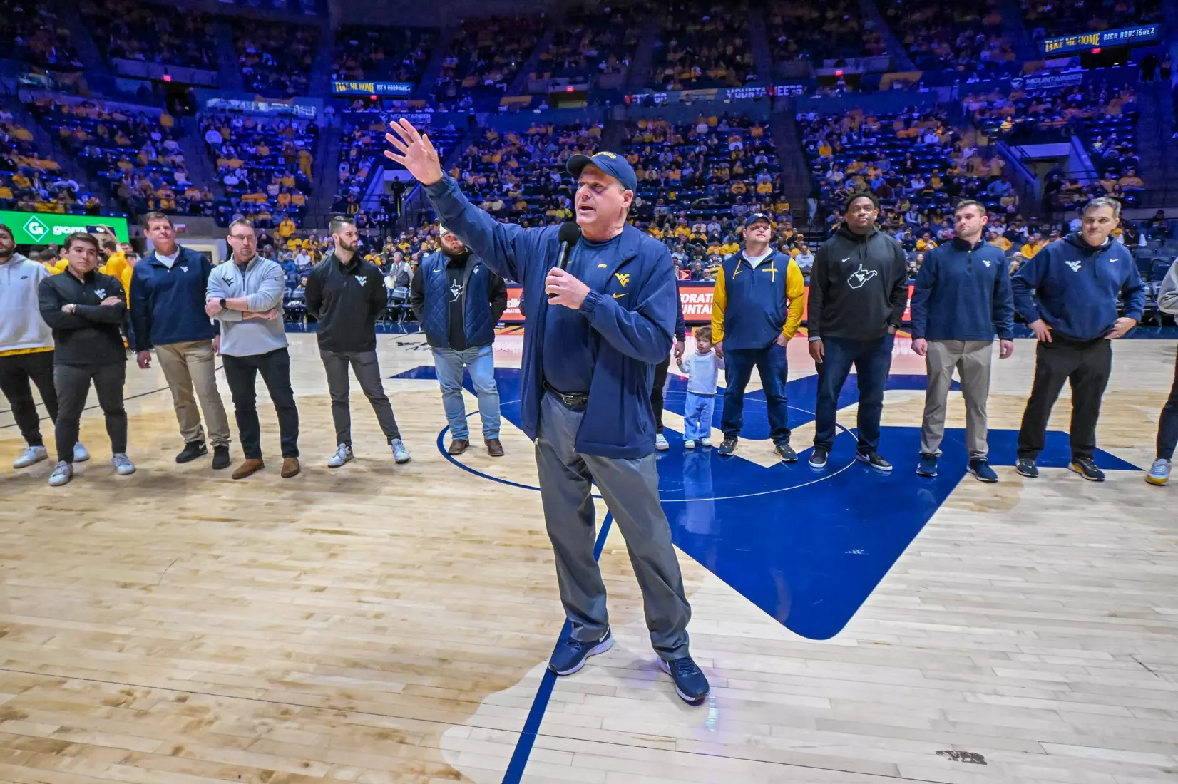 Head football coach Rich Rodriguez and his staff spoke to the crowd during a timeout.
